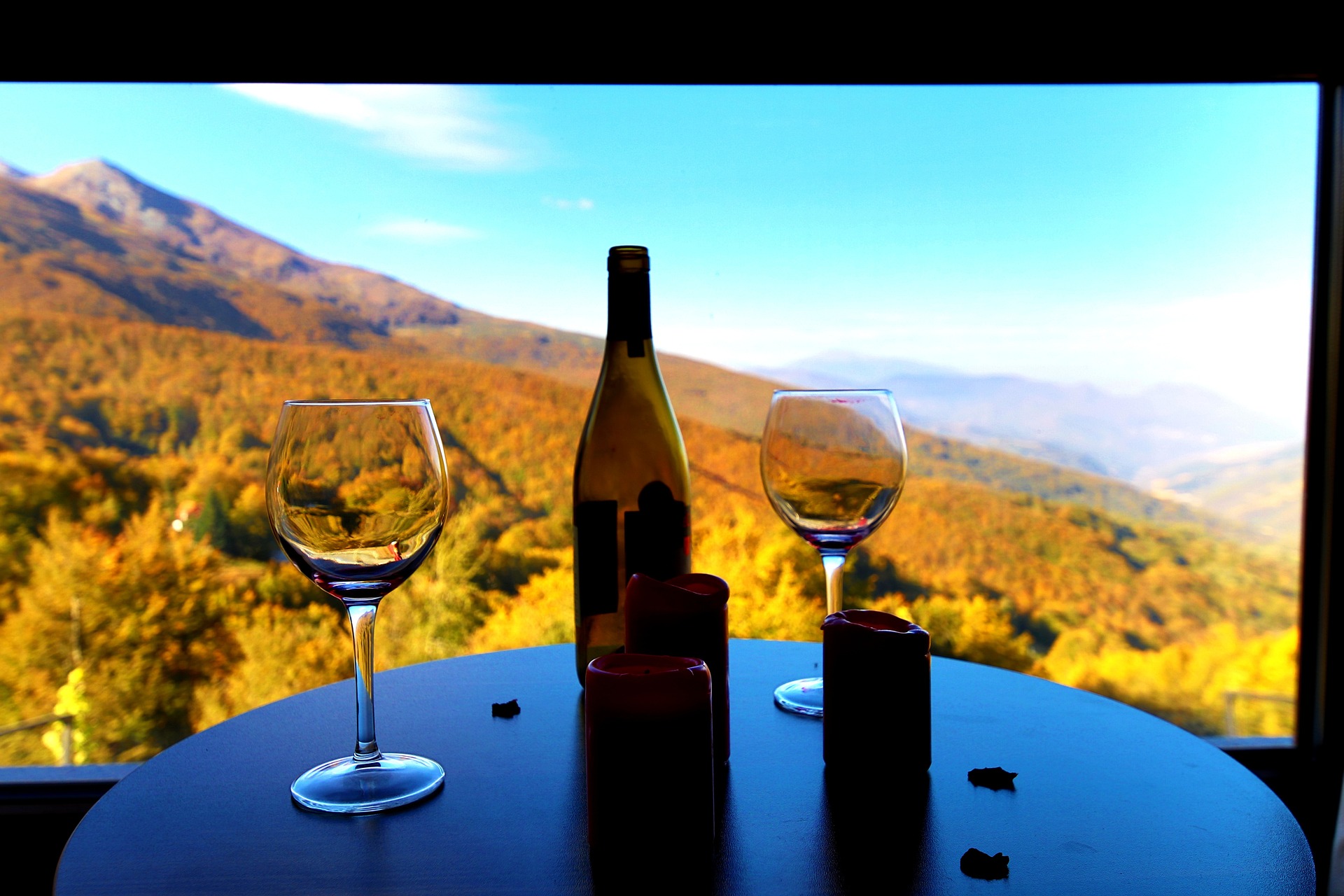 Wine and wine glasses room with view of mountains